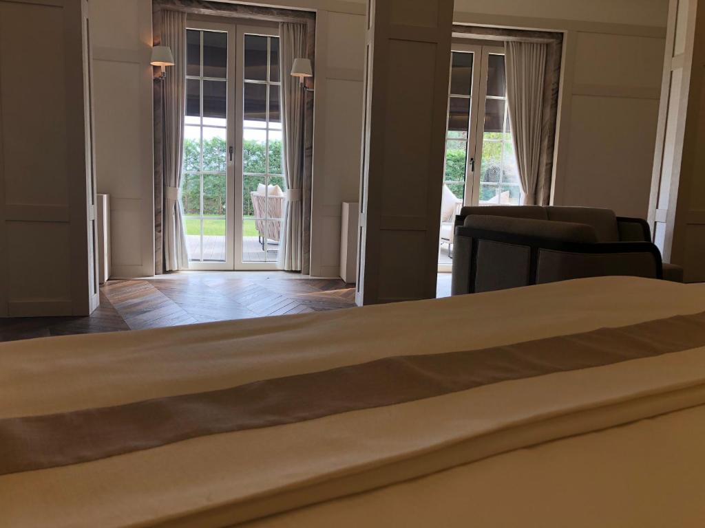 a bedroom with a bed and a living room at Kemer Country Hotel İstanbul in Istanbul
