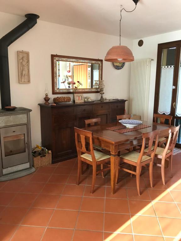 jadalnia ze stołem i krzesłami oraz kominkiem w obiekcie Casa Riccardo w mieście Tavullia