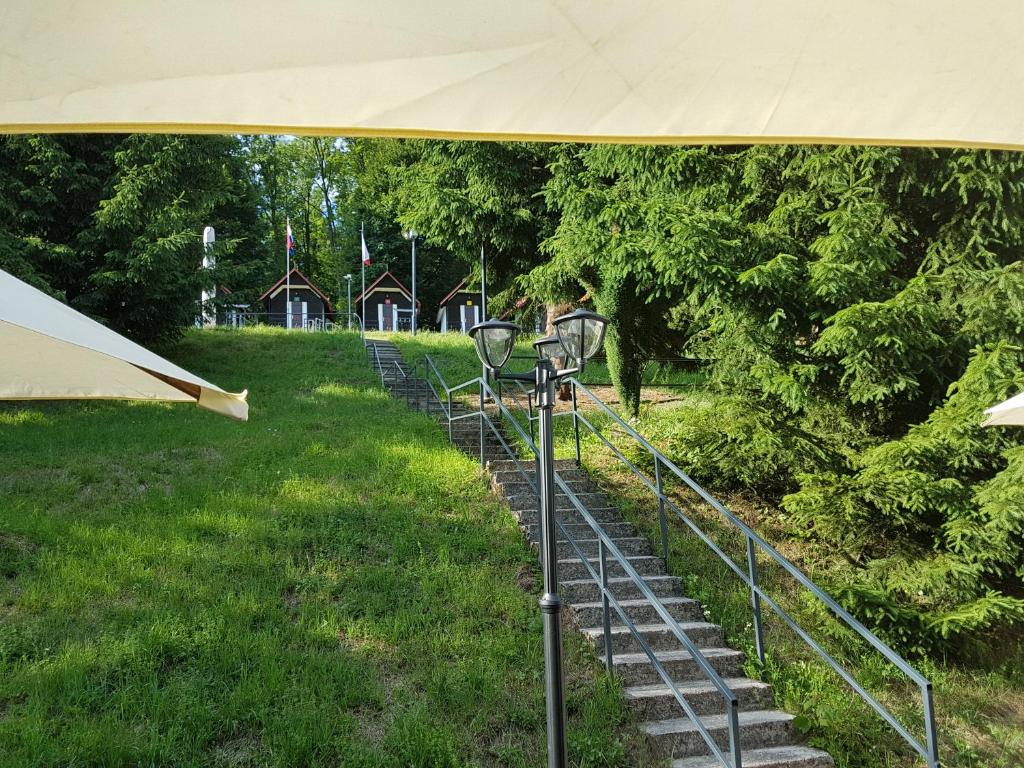 a group of stairs in a park with a tent at Olivin Kytlice Hiker Huts in Kytlice