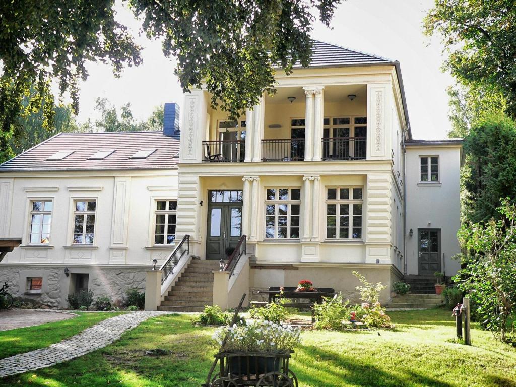 une grande maison blanche avec une cour dans l'établissement Villa Sonntag, à Plau am See