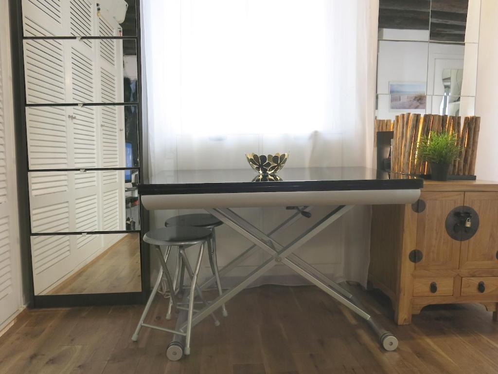 a kitchen counter with a sink and a stool at Studio Marais Charlot CityCosy in Paris