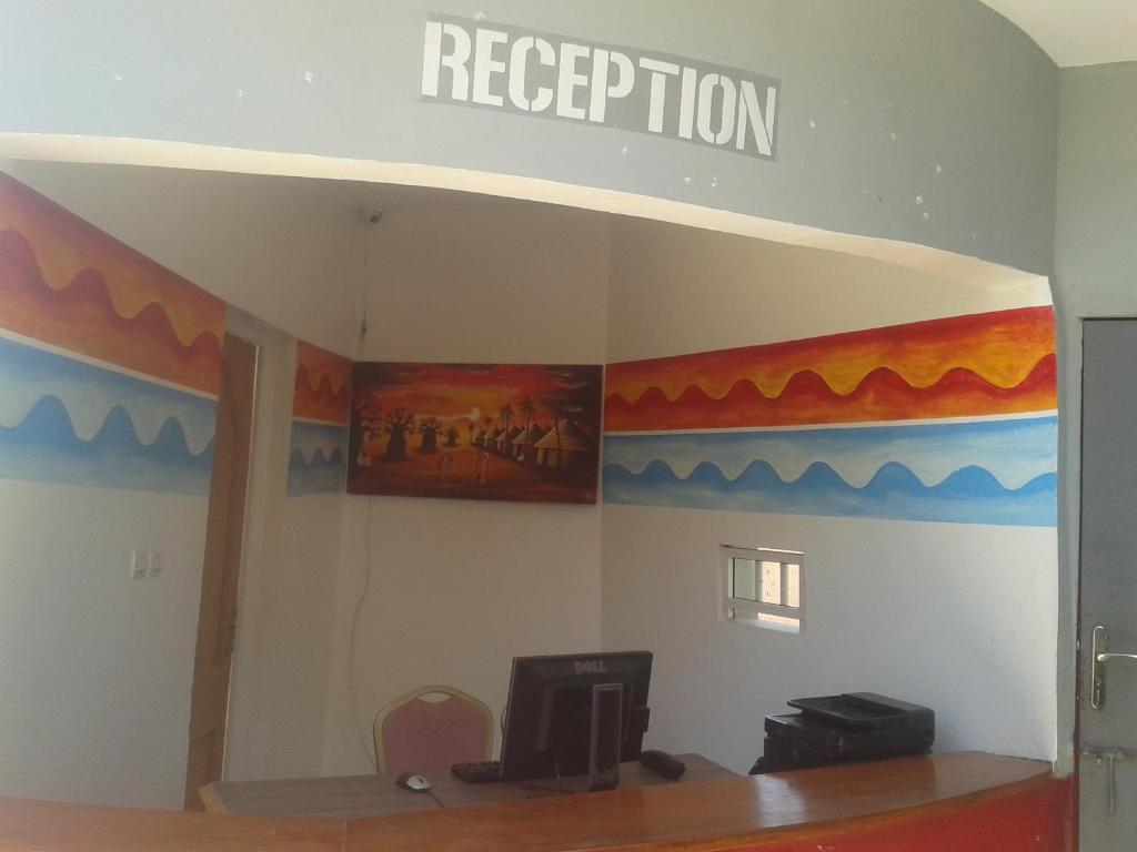 a room with a wall with a sign that reads reception at Melia Hotel in Saly Portudal