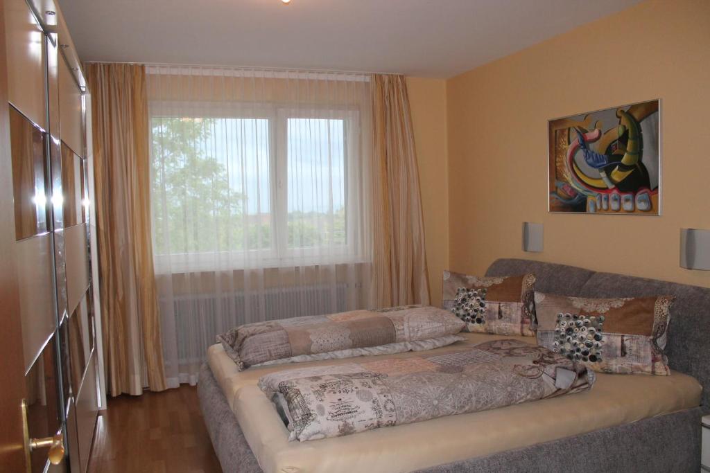 a living room with a couch and a window at Haus Anni in Lochau