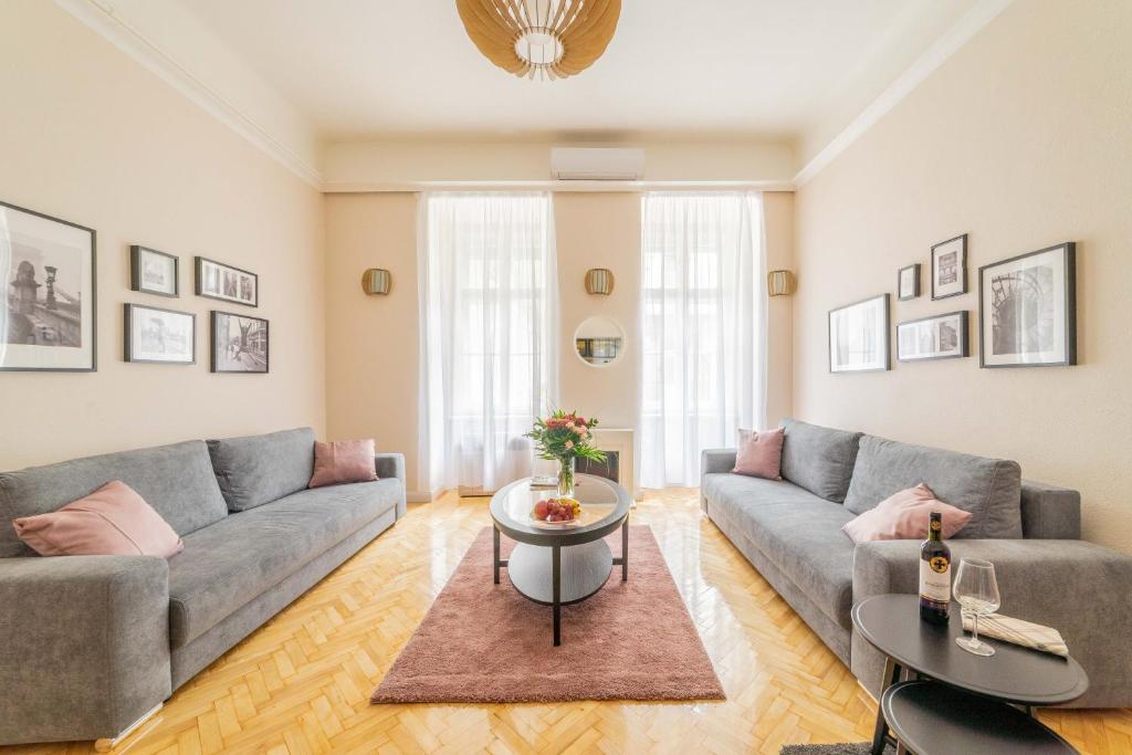 a living room with a couch and a table at Rumbach Residence in Budapest