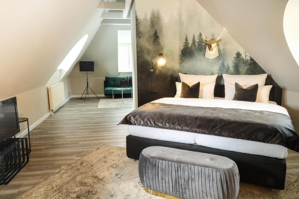 a bedroom with a large bed with a painting on the wall at Meinsbur Boutique Hotel in Bendestorf