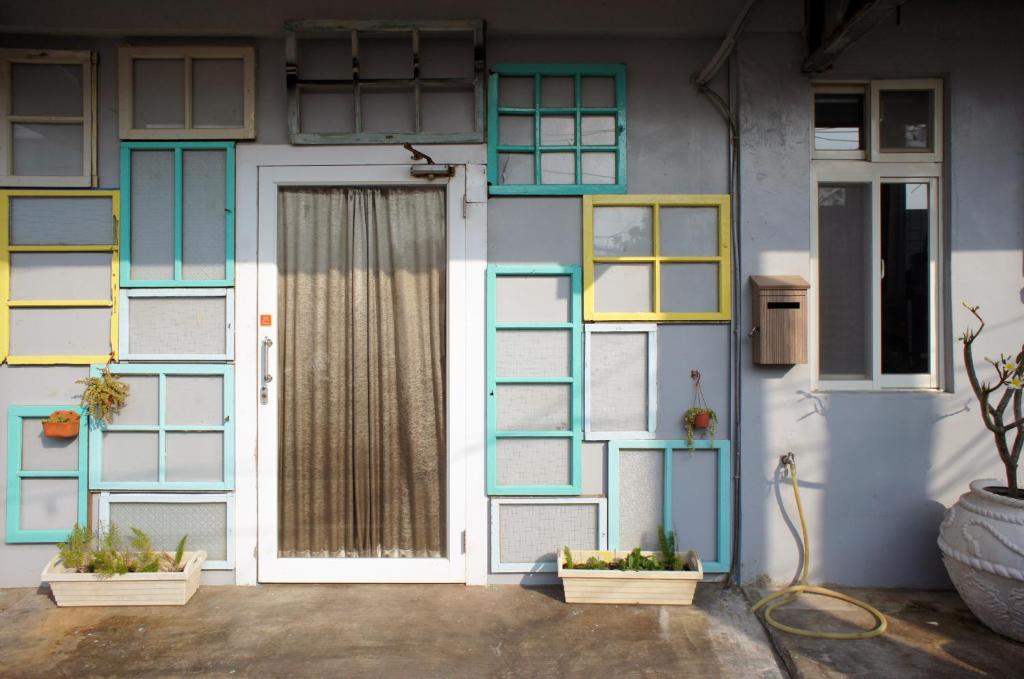 a house with blue and yellow windows and a door at in墾丁 in Kenting