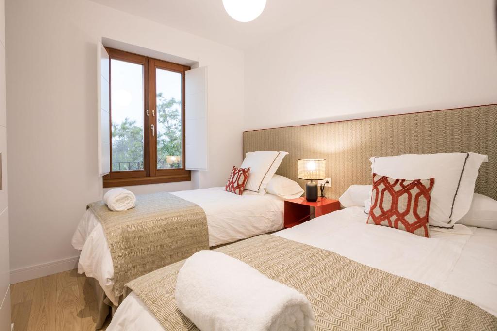 Postel nebo postele na pokoji v ubytování Ohliving Alcazar