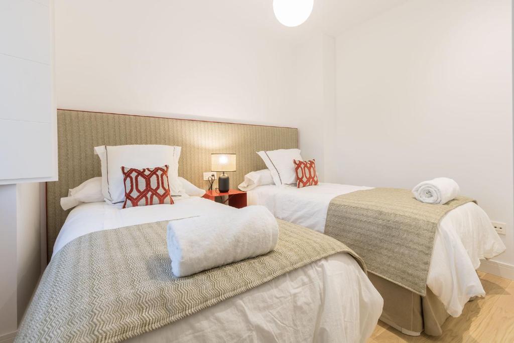 Postel nebo postele na pokoji v ubytování Ohliving Alcazar