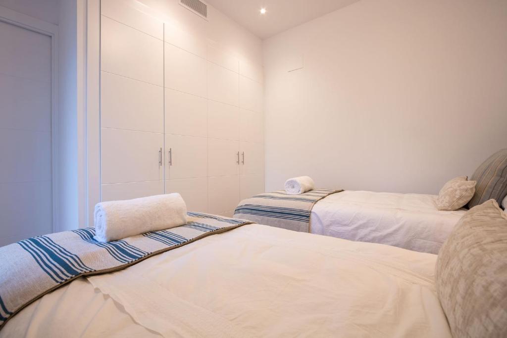 Postel nebo postele na pokoji v ubytování Ohliving Alcazar