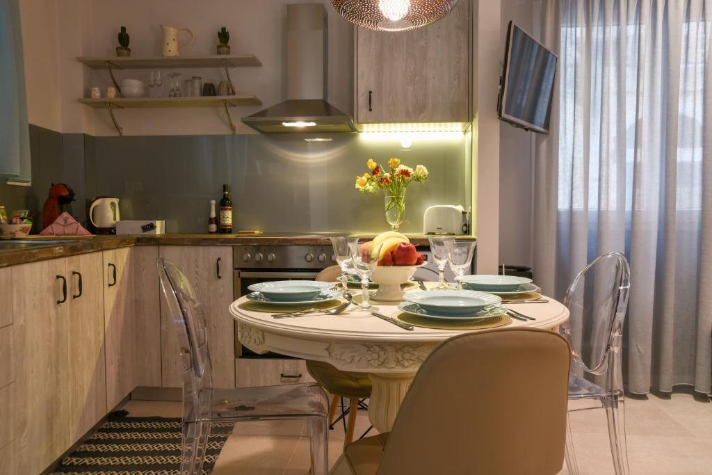 a kitchen with a table and chairs in a kitchen at Suite 16 in Corfu Town