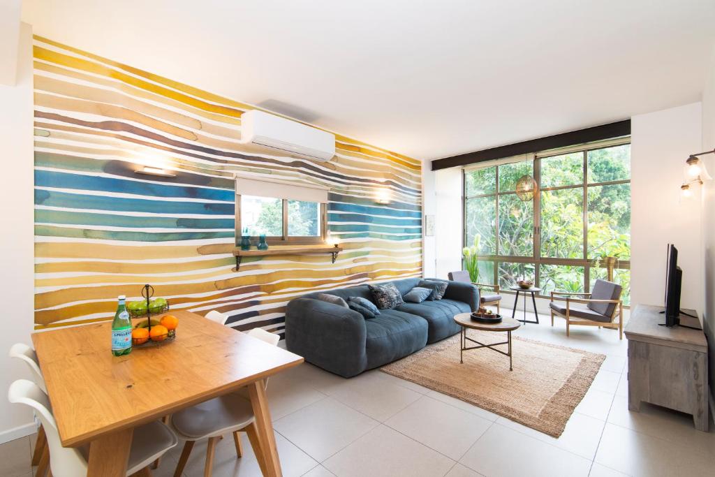 a living room with a couch and a table at Yehuda Central Park by TLV2RENT in Tel Aviv