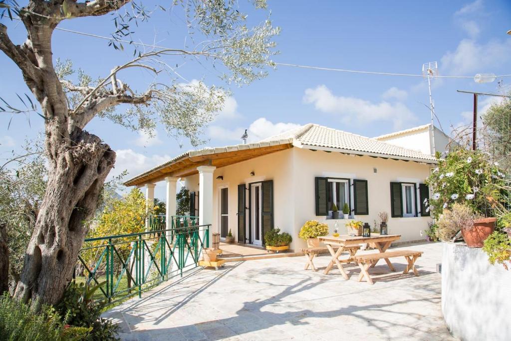 a house with a patio and a table at Elizabeth Country House - 3BR spacious villa in Vragkaniótika