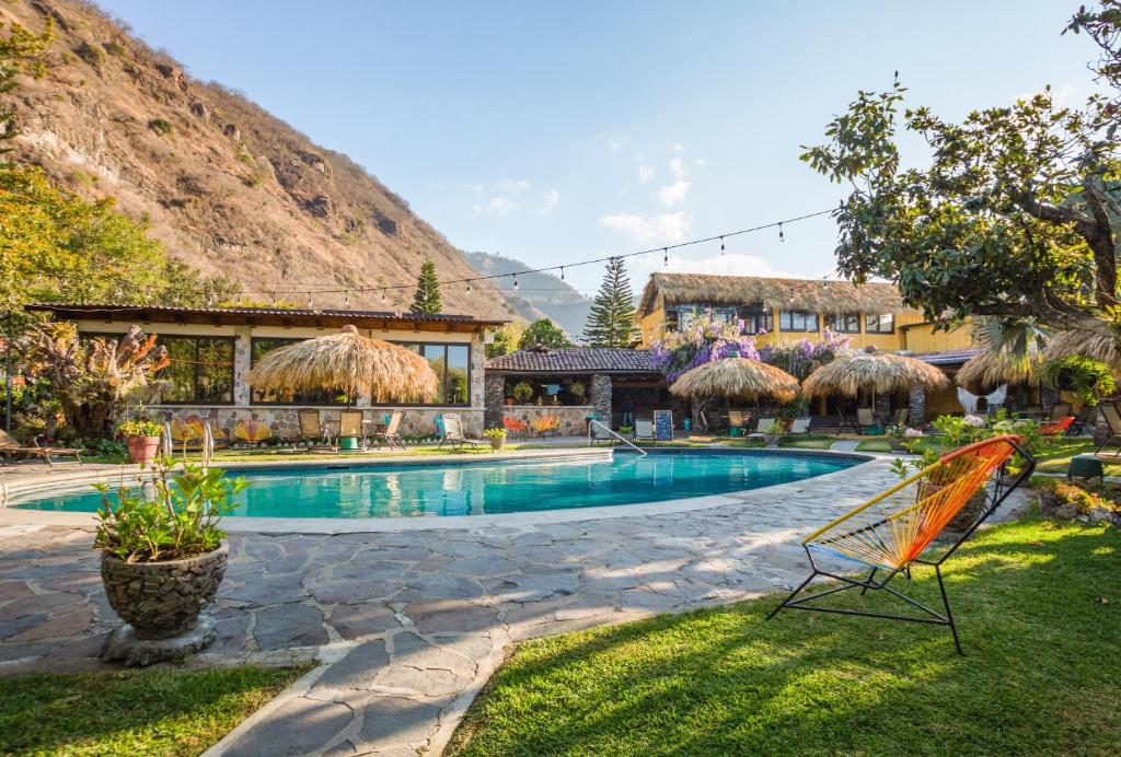 a resort with a swimming pool and a building at Selina Atitlan in Panajachel