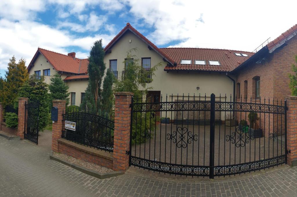 a house with a black wrought iron gate at Villa Mechelinka in Mechelinki
