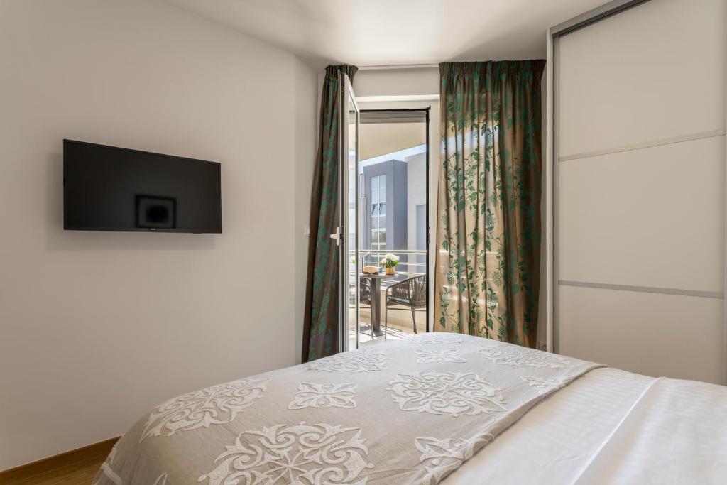 TV a/nebo společenská místnost v ubytování Adriatic Queen Rooms & Apartments