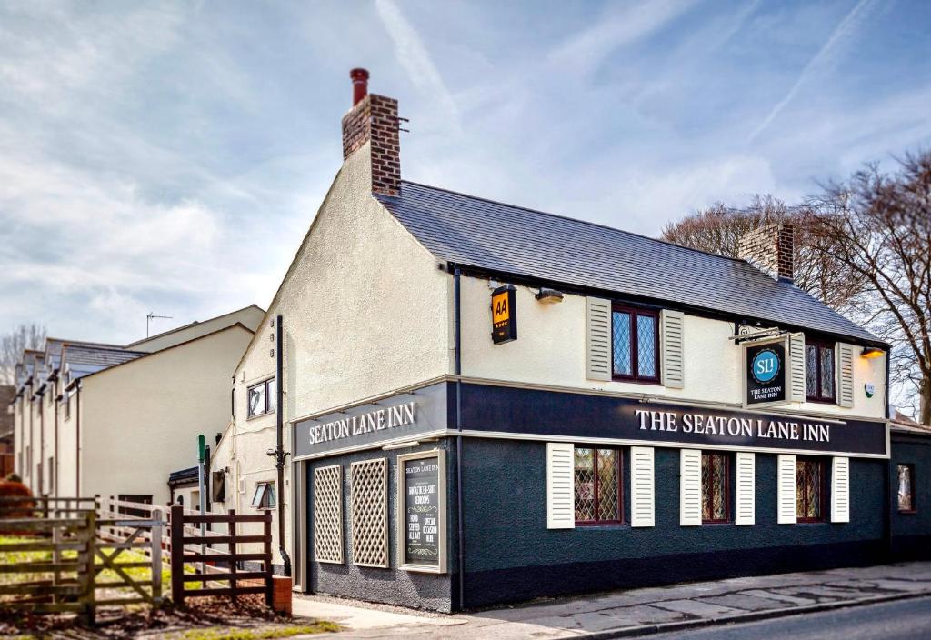 a building with a sign on the side of it at The Seaton Lane Inn - The Inn Collection Group in Seaham
