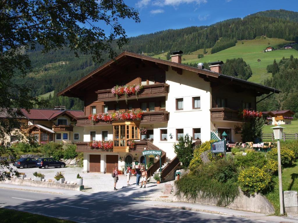 a building with people walking in front of it at Salzburger Stubn in Kleinarl