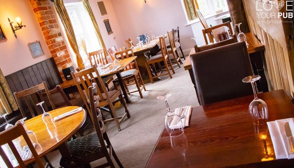 a dining room with tables and chairs in a restaurant at The Rising Sun Inn in Waterlooville