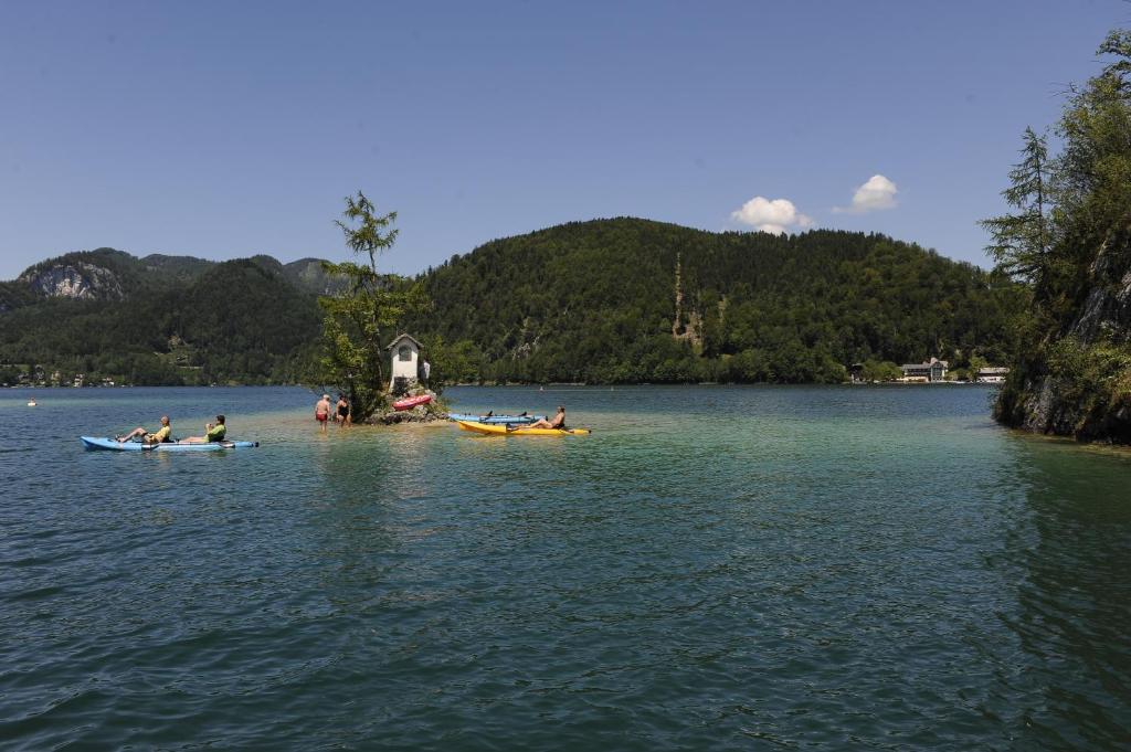 a group of people in kayaks on a lake at Hotel & Gasthof Fürberg in Sankt Gilgen