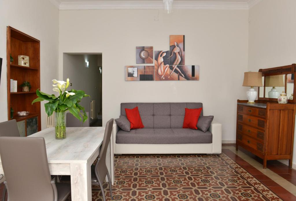 a living room with a couch and a table at Niria Home in Catania