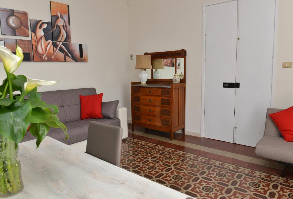 a living room with a couch and a table at Niria Home in Catania