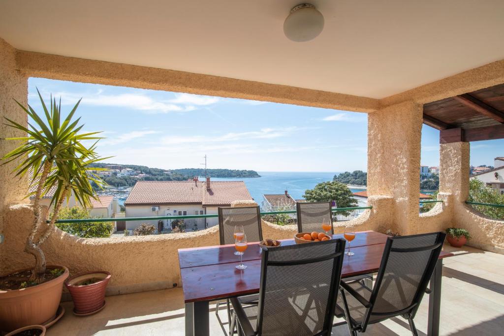 a patio with a table and a view of the ocean at Horizont view apartment in Pula