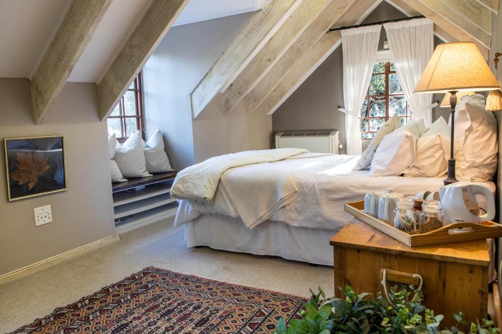 a bedroom with a large bed and a table at The Bergzicht Guest Suite in Cape Town