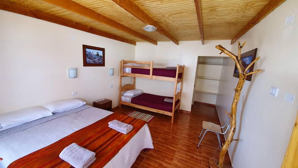 Postel nebo postele na pokoji v ubytování Hostal Ckamai