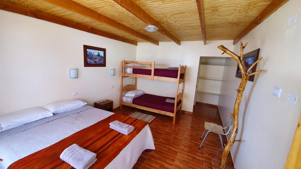 Cama ou camas em um quarto em Hostal Ckamai