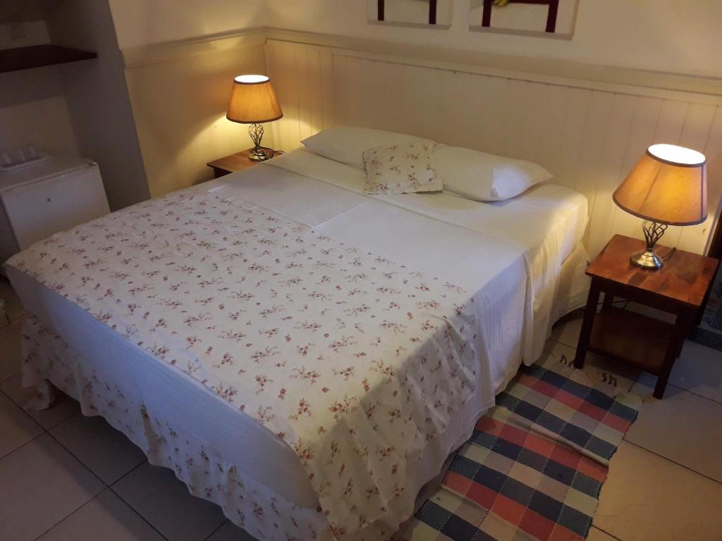 Cama ou camas em um quarto em Recanto da Praia