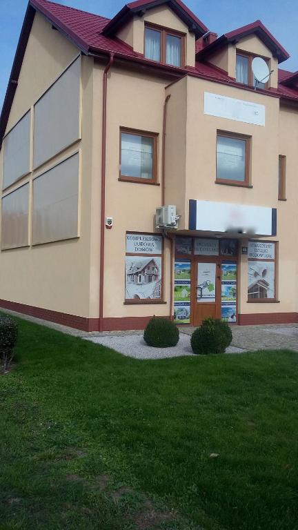 a building with signs on the side of it at APARTAMENT NA DOBY - LUBIN in Lubin