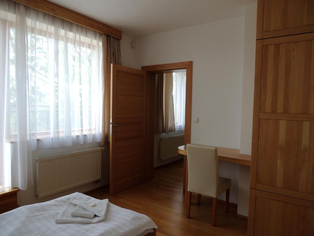 Postel nebo postele na pokoji v ubytování Rezidence & Wellness Blatov