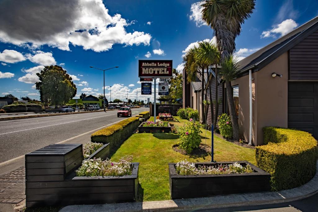 a hotel with a sign on the side of the road at ASURE Abbella Lodge Motel in Christchurch