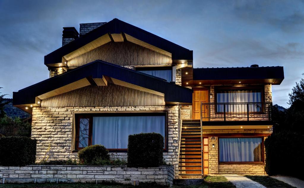 a brick house with a balcony in front of it at Las Liebres in San Carlos de Bariloche