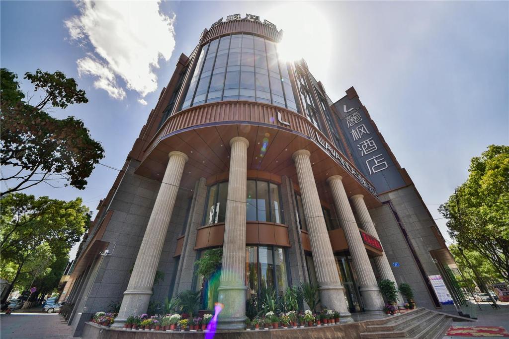 a large building with pillars in front of it at Lavande Hotel Dali Erhai Park Branch in Dali