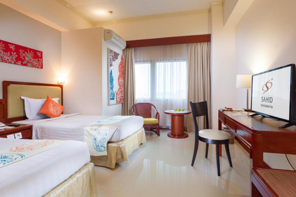 Postel nebo postele na pokoji v ubytování Hotel Sahid Surabaya