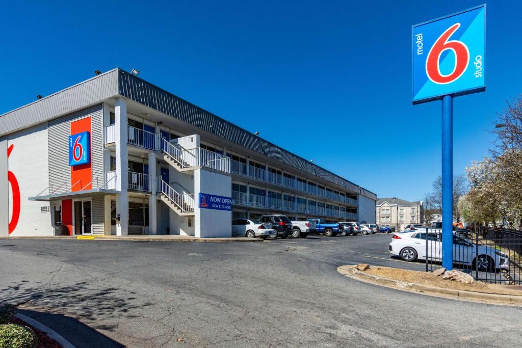a building with cars parked in a parking lot at Studio 6-Little Rock, AR - West in Little Rock