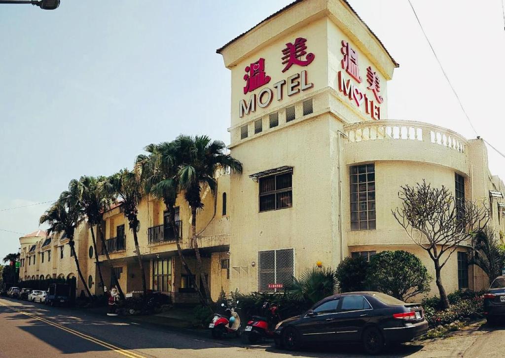 a hotel with a sign on the side of a building at Wen Mei Motel in Nantou City