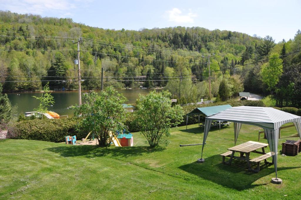 a gazebo and a picnic table in a yard at Le Boisé du Lac in Mont-Tremblant