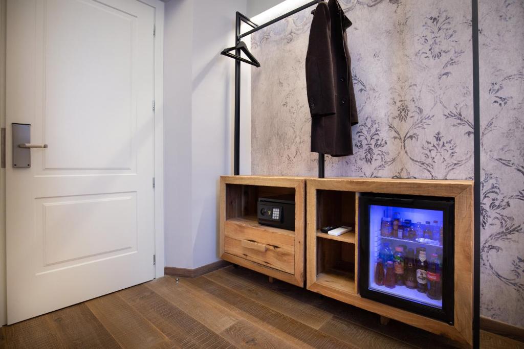 a living room with a tv on a wooden entertainment center at Palazzo dei Conti Residenza d'Epoca in Florence