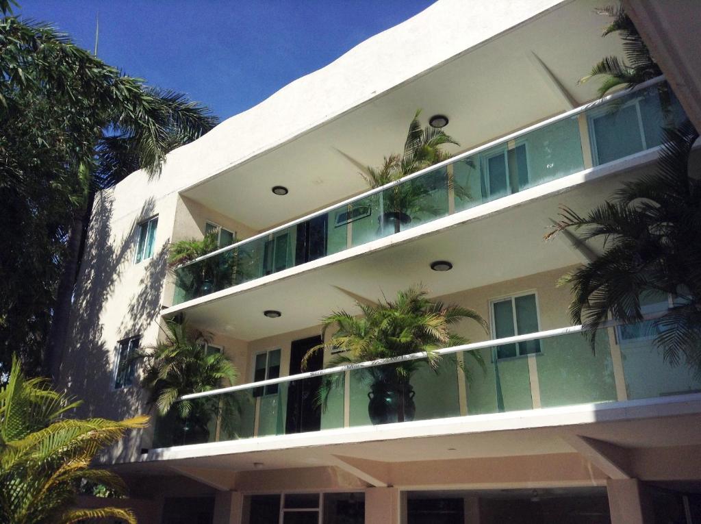 a large building with a balcony and a balcony view at Hotel Chapul Inn in Acapulco