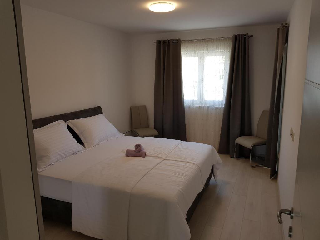 Postel nebo postele na pokoji v ubytování Apartmani MARELLA