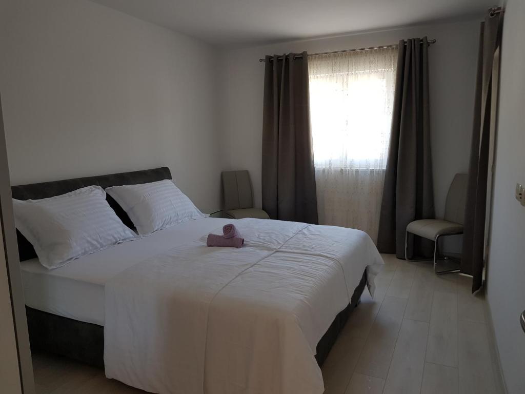 Postel nebo postele na pokoji v ubytování Apartmani MARELLA