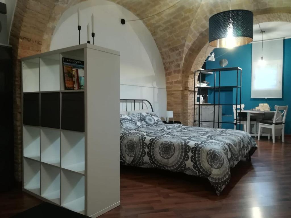 a bedroom with a bed and a dining room at B&B Piccolo Loft del Borgo in Lanciano