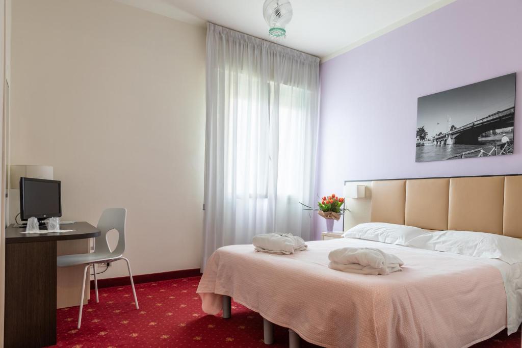Postel nebo postele na pokoji v ubytování Hotel Columbia Terme