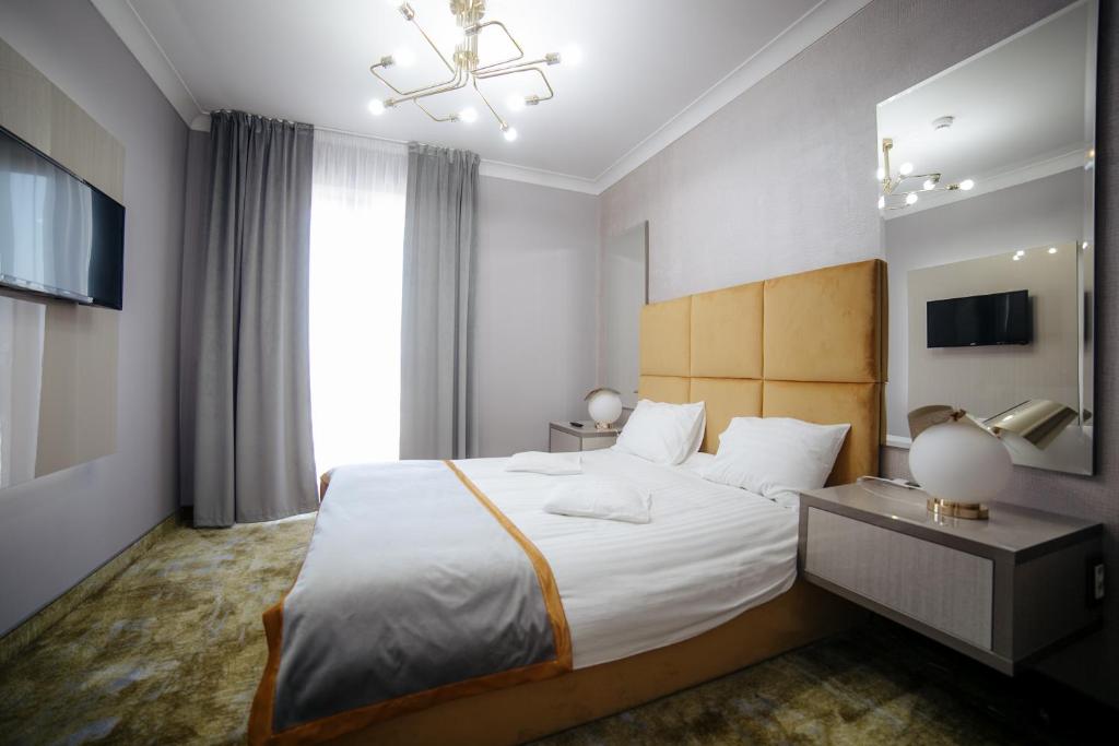 Postel nebo postele na pokoji v ubytování Royal Class Hotel