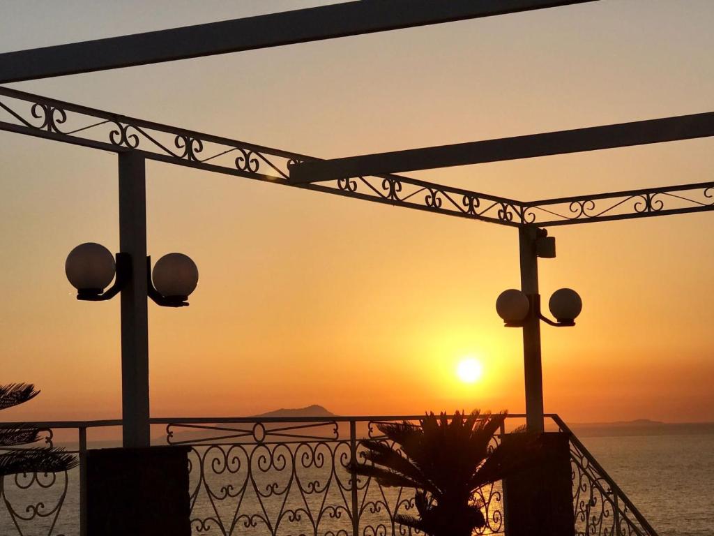 a view of the sunset from a balcony at Hotel Dania in Sorrento