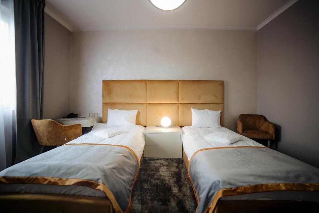 Postel nebo postele na pokoji v ubytování Royal Class Hotel
