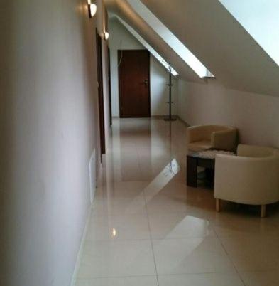 a hallway with a couch and a chair in a building at Noclegi Lidzbark -Stacja Paliw k Lidzbarka in Lidzbark
