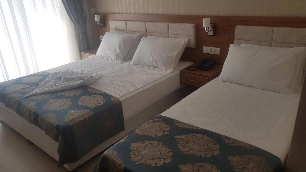 Postel nebo postele na pokoji v ubytování OLYMPIC HOTELS Belek